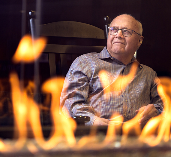 Four women wearing Gonzaga gear stand in a row through a window.
